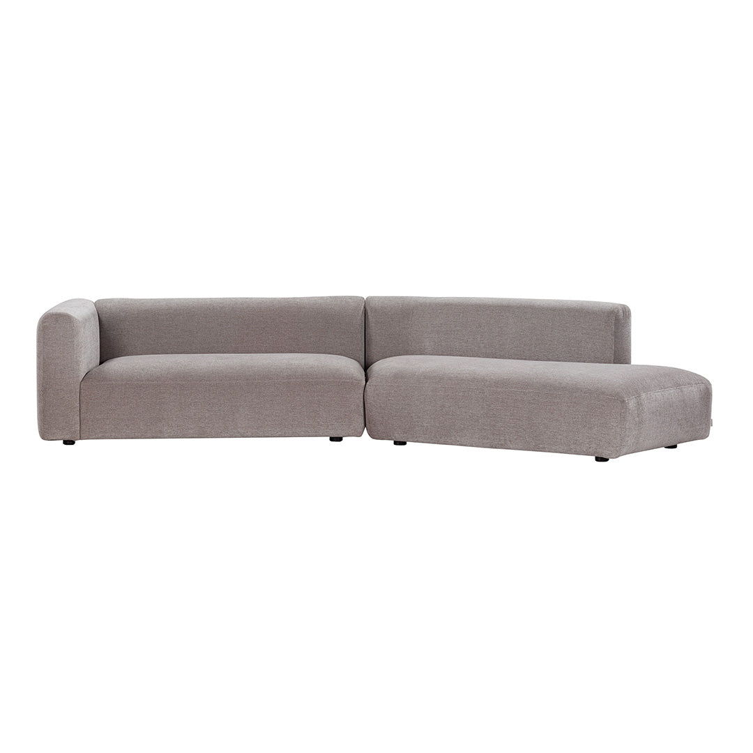 Gray sectional sofa with smooth, modern upholstery and minimalistic design, featuring soft, contemporary lines.