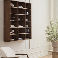 Wooden bookshelf with a rich brown finish and a minimalist design, featuring clean lines and organized white and neutral decor.