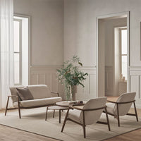 "Neutral beige seating with soft textures, paired with light wood accents and green plants in a serene, minimalist setting."