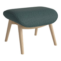 Teal patterned upholstery on a rounded ottoman with light wooden legs, adding a modern touch to any space.
