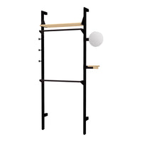 Black metal frame with natural wood shelves and a round white light fixture. Minimalist design with sleek lines.