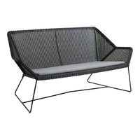Stylish black wicker loveseat with grey cushions and modern wireframe legs, perfect for outdoor or indoor decor.