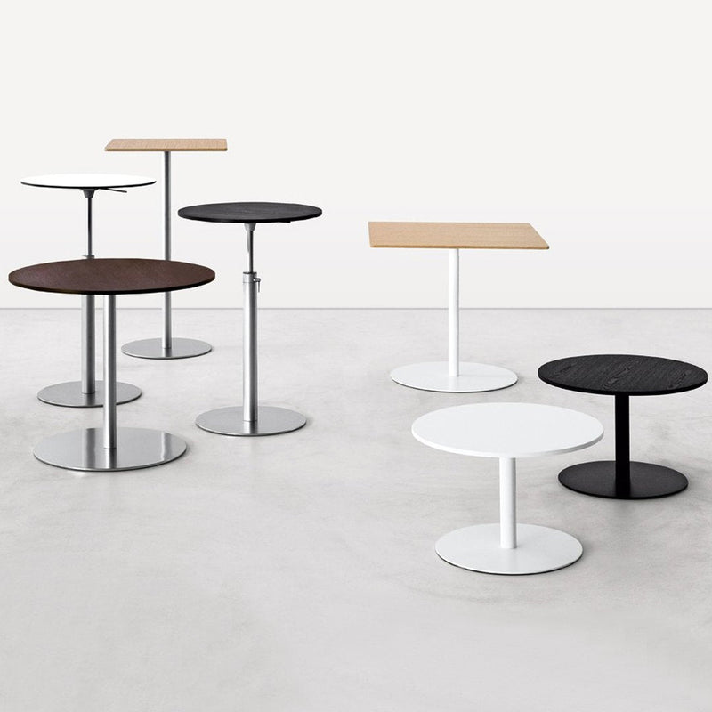 Various round and square side tables in black, white, light wood, and dark wood with sleek metal bases.