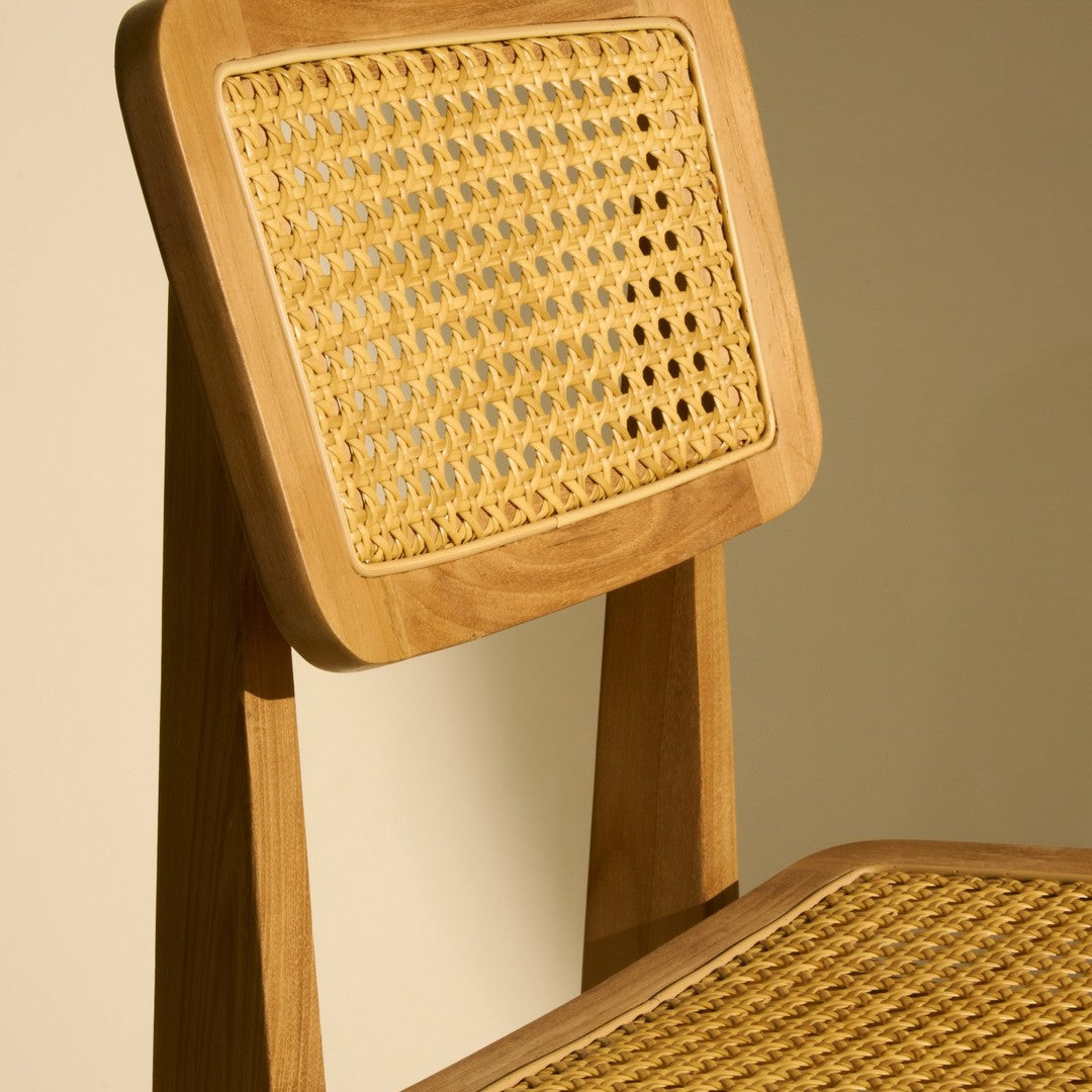"Light wood chair with natural cane weave, featuring a warm beige and golden pattern."