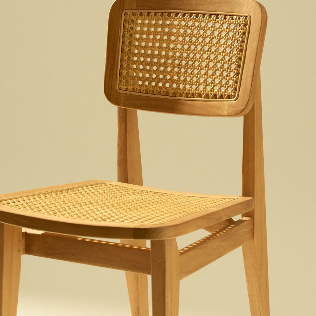 Natural wood chair with a light honey finish and woven cane pattern on the seat and backrest.