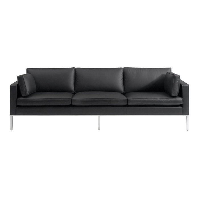"Modern black leather sofa with sleek lines and plush cushions, featuring a minimalist design and silver legs."