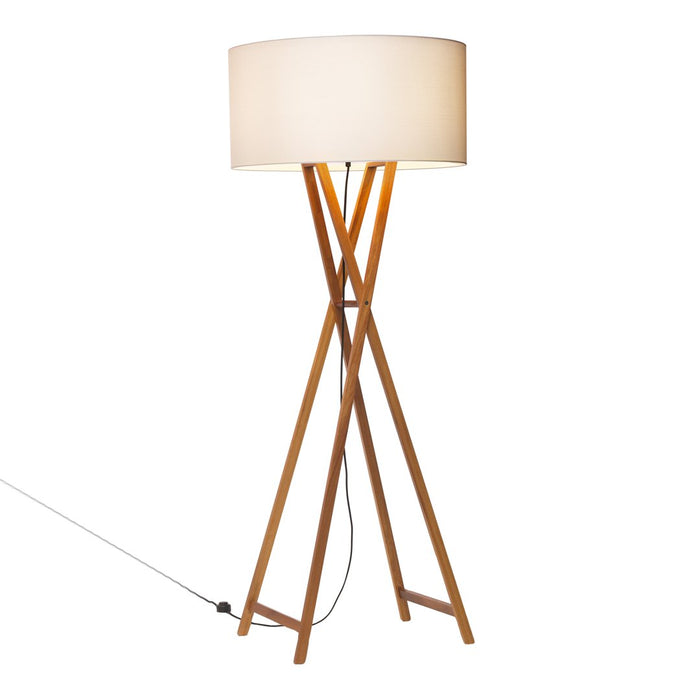 Tall wooden tripod floor lamp with a soft white drum shade, featuring a warm, natural wood finish.