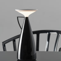 Sleek black modern lamp with a white top, featuring a minimalist design and glossy finish. Perfect for contemporary decor.