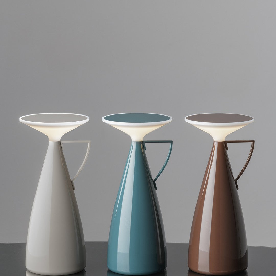 Modern lamp trio in gray, teal, and brown with sleek, glossy finishes and soft, illuminated tops.
