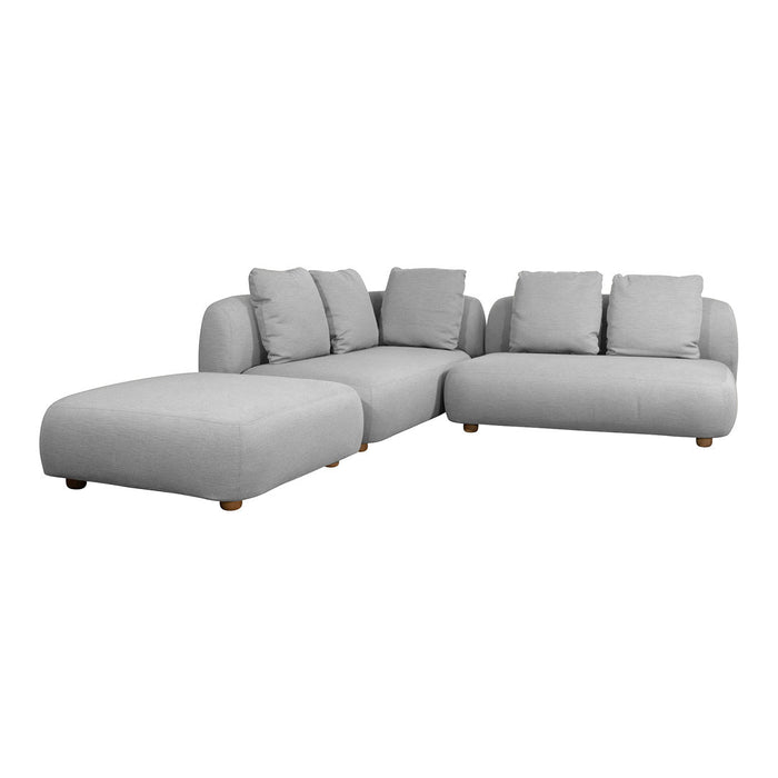 Light gray sectional sofa with plush cushions and smooth upholstery. Minimalist design with rounded edges and wooden legs.