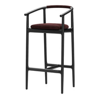 Stylish black bar stool with a rich burgundy seat cushion and contrasting textured handle detailing.