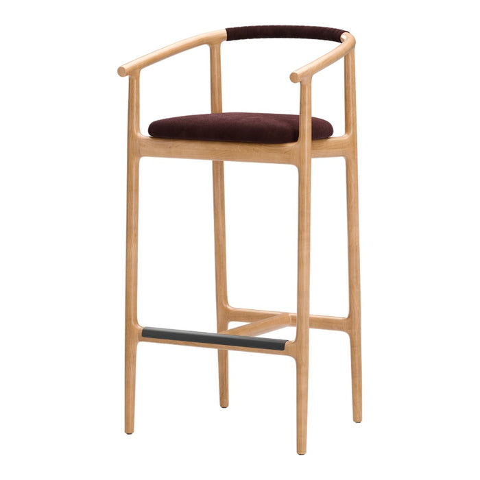 Wooden bar stool with a light natural finish, dark brown upholstered seat, and black footrest detail.