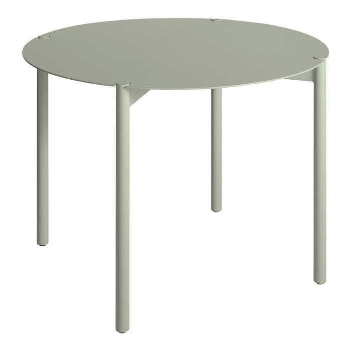 Round table in soft green finish, sleek legs, minimalist design, perfect for modern décor.