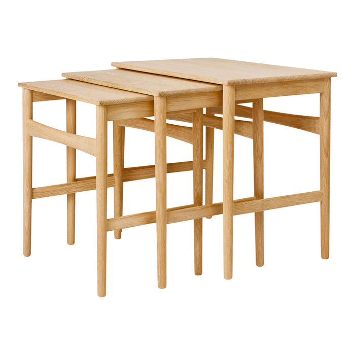 Set of three nesting tables in natural wood finish, featuring a smooth, light grain texture. Ideal for versatile decor.