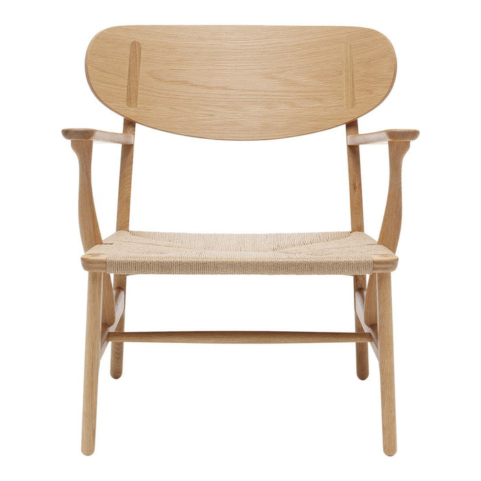 Light oak chair with a natural woven seat and minimalist design, showcasing smooth wood grain and soft curves.