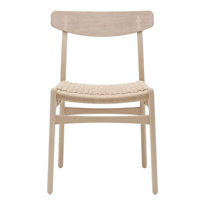 Natural wood finish chair with woven seat, showcasing a minimalist design in soft beige tones.