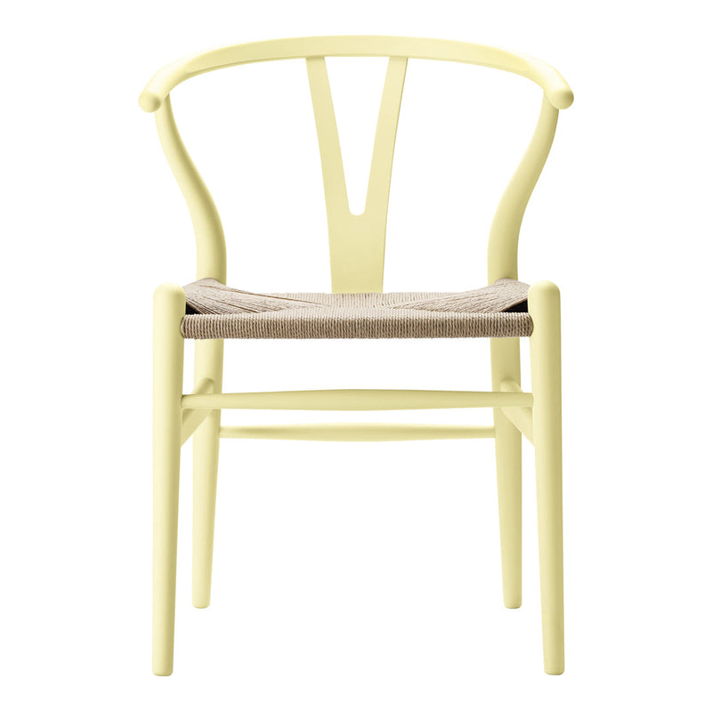 Light yellow wooden chair with a natural woven seat, showcasing a minimalist design and simple lines.