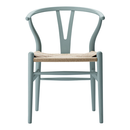 Light blue wooden chair with a woven natural fiber seat and sleek, minimalistic design.