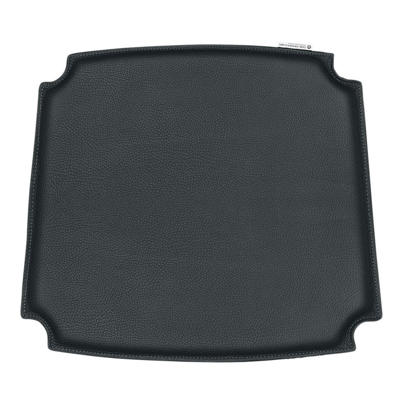 Black square grill mat with a smooth textured surface and rounded corners, perfect for cooking and grilling.