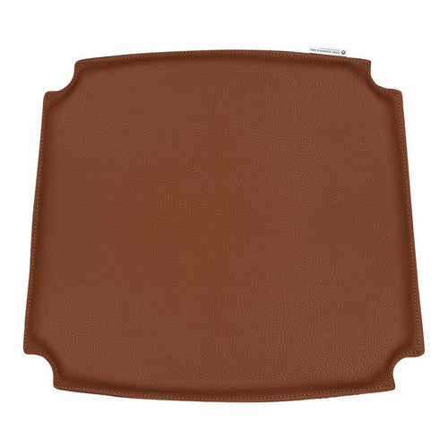 Brown square silicone baking mat with smooth surface and rounded corners, ideal for easy baking and cooking.