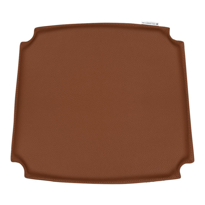 Brown square silicone baking mat with smooth surface and rounded corners, ideal for easy baking and cooking.