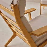 Light beige upholstery with a textured pattern, paired with natural wood accents in a minimalist design.