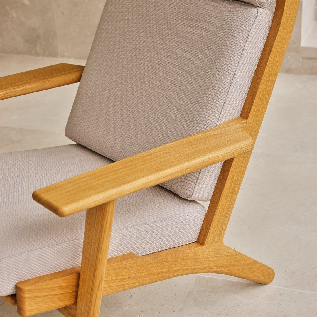 Light beige cushioned chair with natural wood accents and clean lines, perfect for modern decor.