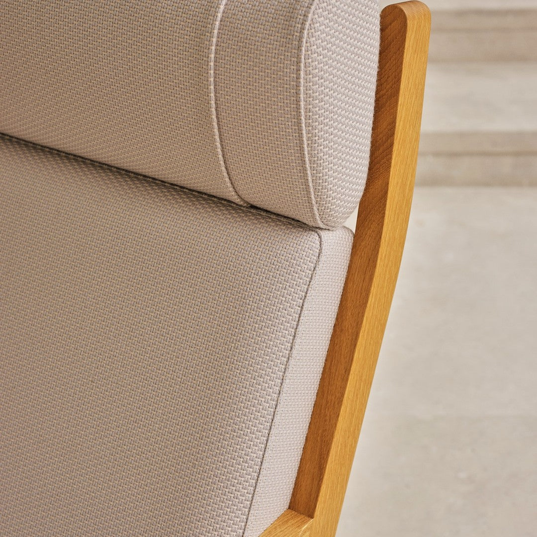 Light beige textured upholstery with a natural wood frame, showcasing a subtle, modern pattern.