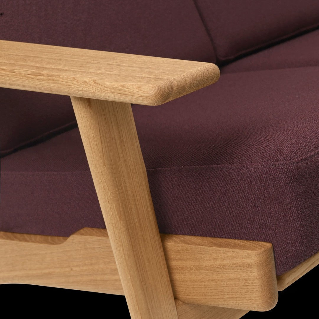 Purple fabric upholstery with a smooth finish and natural wood frame, showcasing modern design and elegant contrast.