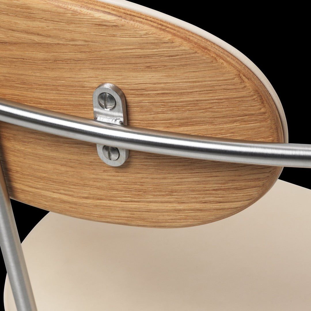 Natural wood grain with a smooth finish, complemented by sleek metallic accents and a neutral beige seat.