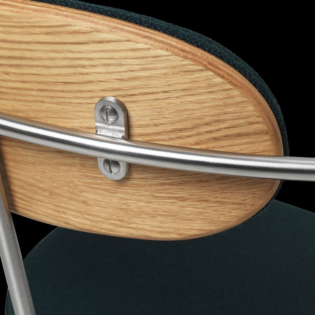 Wooden chair back with a light oak finish, silver metal accents, and deep green upholstery.