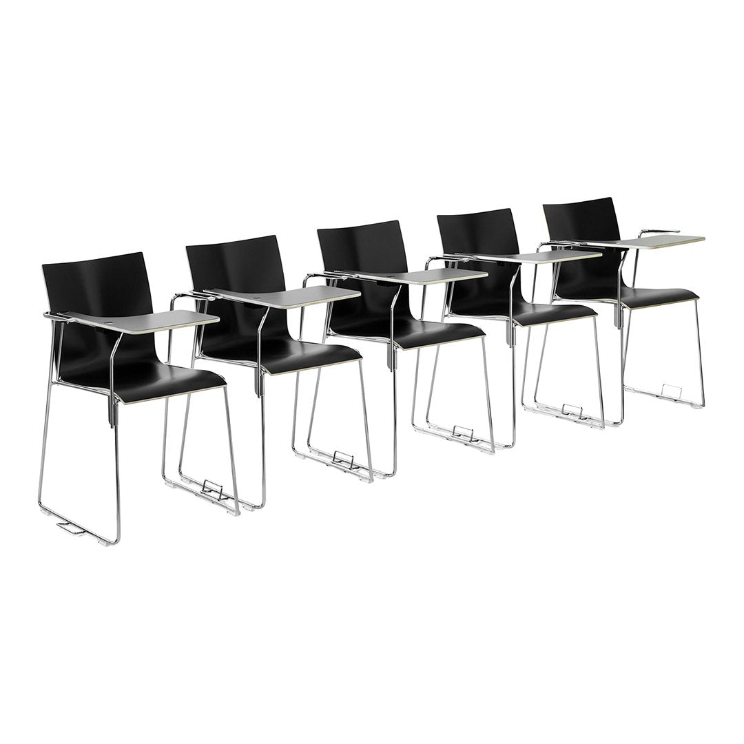 Set of five sleek black chairs with minimalist design, featuring chrome legs and attachable writing surfaces.