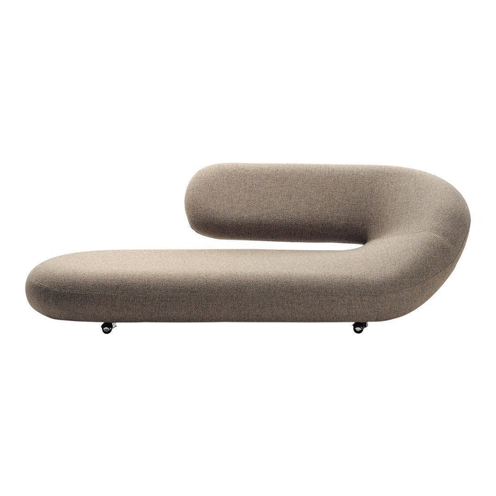 Chic taupe chaise lounge with a sleek curved design and a soft textured finish, perfect for modern interiors.