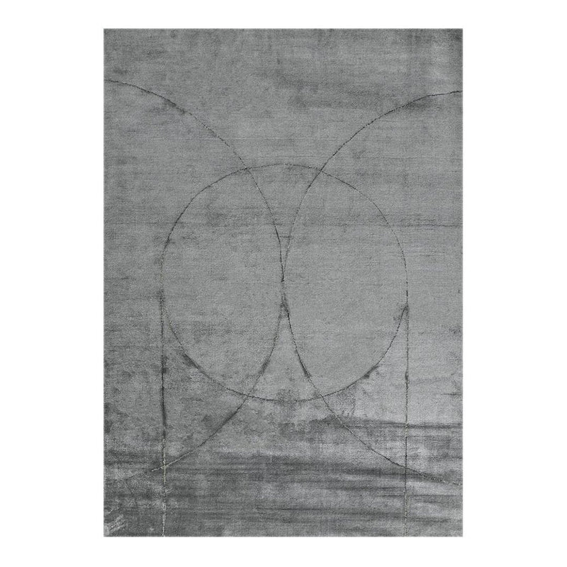Gray area rug with abstract circular patterns and a textured finish, adding a modern touch to any space.