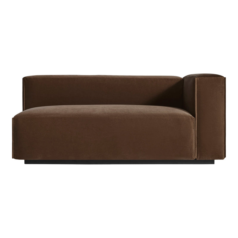 Brown velvet chaise lounge with a minimalist design and sleek, modern lines on a black base.