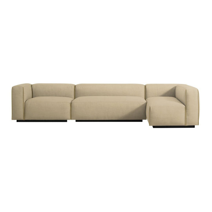 Beige sectional sofa with a minimalist design, featuring soft, smooth upholstery and sleek black base.