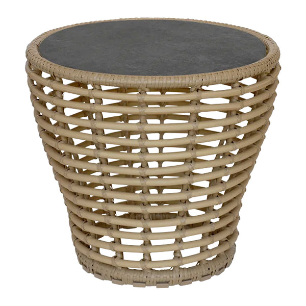 Round rattan side table with natural beige weaving and a sleek black top. Perfect blend of texture and color for any space.