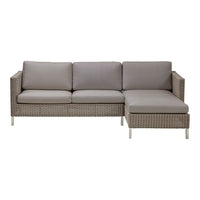 Gray outdoor sectional sofa with sleek lines and light woven rattan pattern. Comfortable, modern design for patio seating.