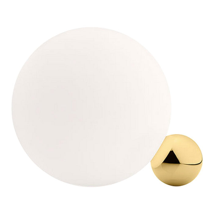 White round sphere and glossy gold triangular-shaped accent, minimalist design with contrasting colors.