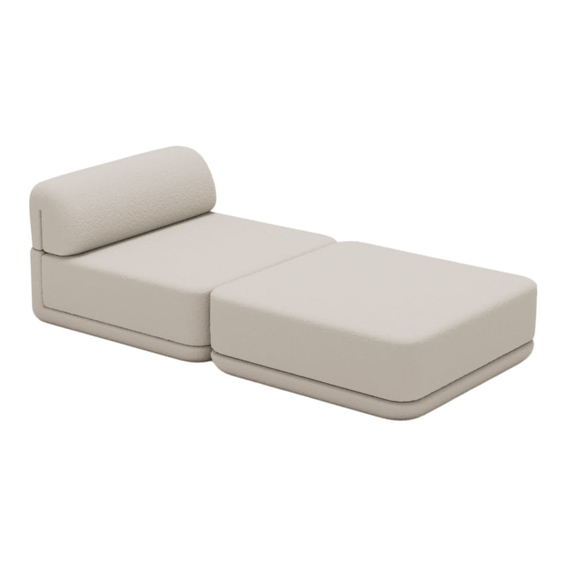 Beige modular lounge chair with smooth, minimalist design, featuring solid color and no visible patterns.