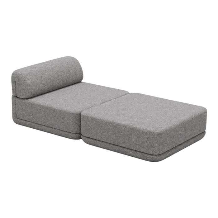 Gray modular chaise lounge with a smooth, textured surface and minimalist design, perfect for modern spaces.