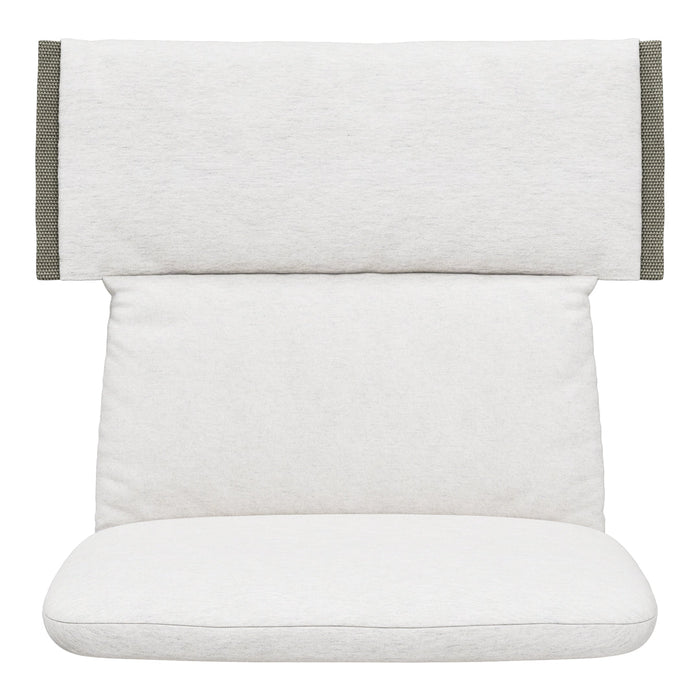 White cushion with textured fabric and olive green accents, featuring a minimalist design for a modern aesthetic.