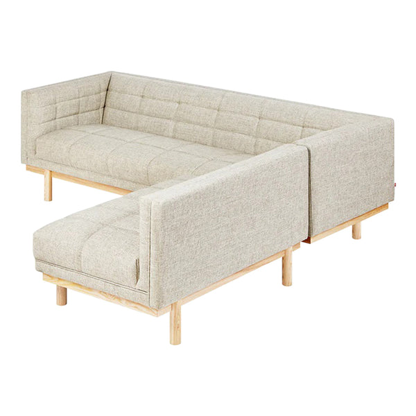 Light beige sectional sofa with a tufted pattern and natural wood legs, adding a modern touch to any living space.