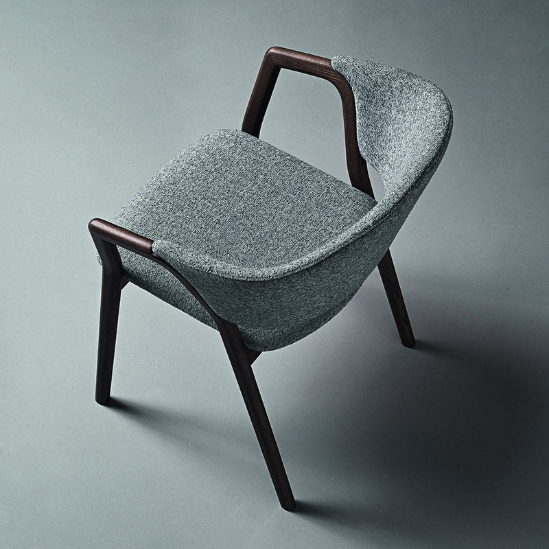 Gray upholstered chair with a smooth texture and dark wooden legs, showcasing a modern, minimalist design.