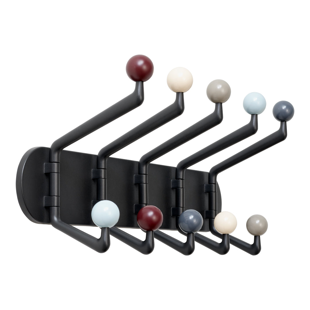 Black wall coat rack with colorful round hooks in burgundy, cream, gray, and blue. Modern design with playful patterns.