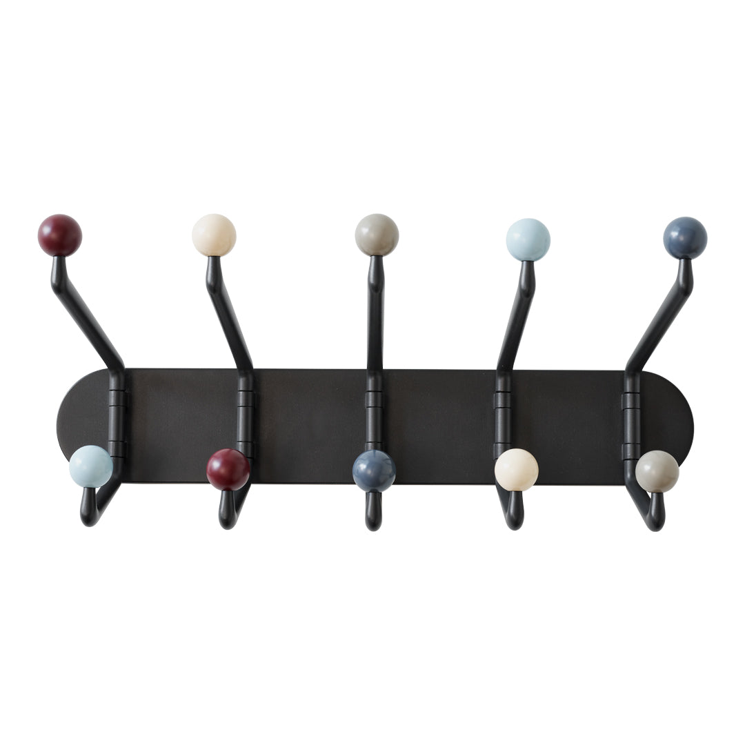 Multi-colored wall hooks featuring round knobs in red, blue, cream, and black on a sleek black backdrop.