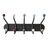 Multi-colored wall hooks featuring round knobs in red, blue, cream, and black on a sleek black backdrop.