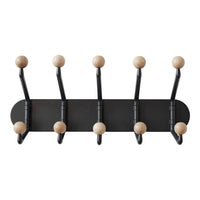 Black wall-mounted coat rack with six wooden ball hooks, featuring a modern and minimalist design. Perfect for any decor.