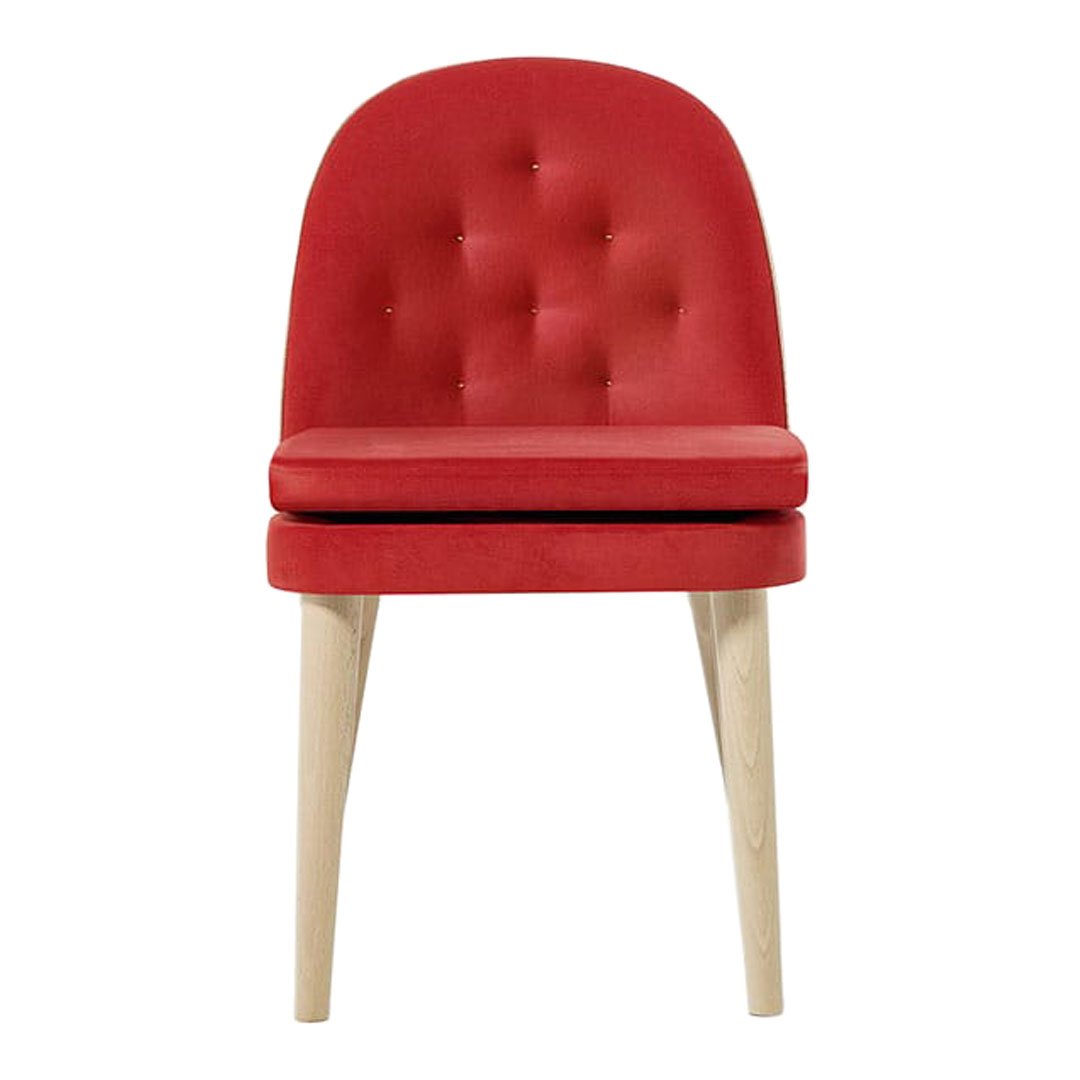 Red tufted chair with smooth upholstery and light wooden legs, perfect for modern decor.