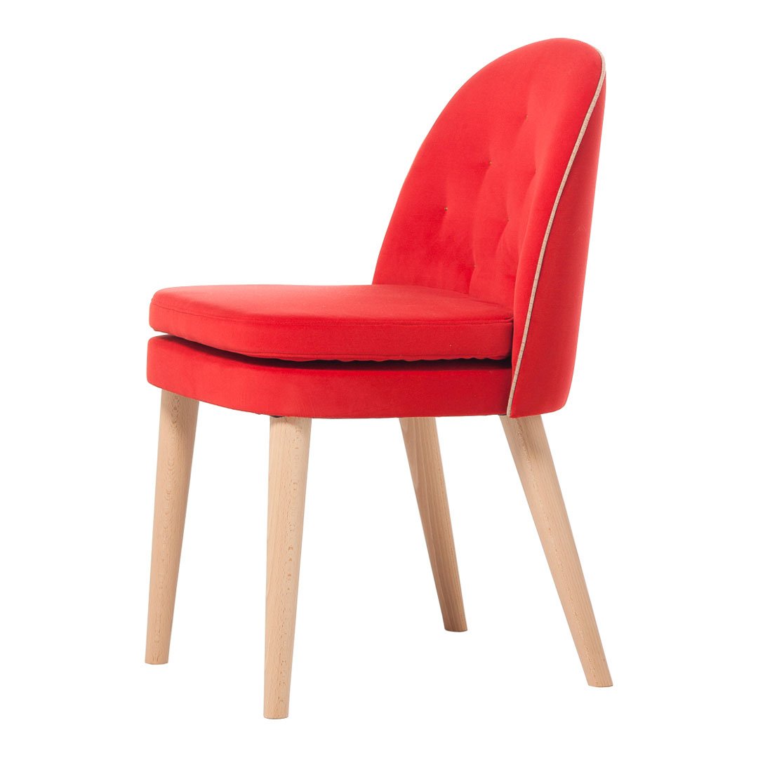 Red upholstered chair with tufted design and natural wood legs, featuring a smooth, modern silhouette.